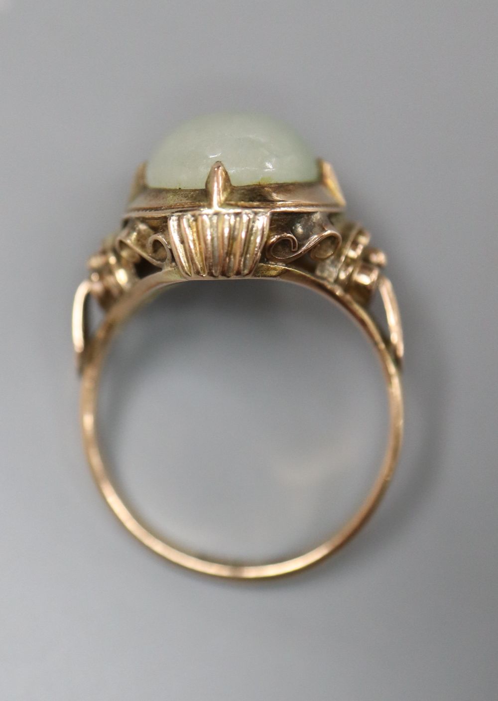 A 14k yellow metal and oval cabochon jade set ring, size L/M, gross 5 grams.